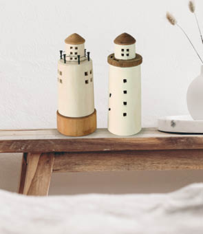 Modern white ceramic vase with dry Lagurus ovatus grass and marble tray on vintage wooden bench, table  Blurred beige linen blanket in front  Scandinavian interior, empty white wall, copy space 