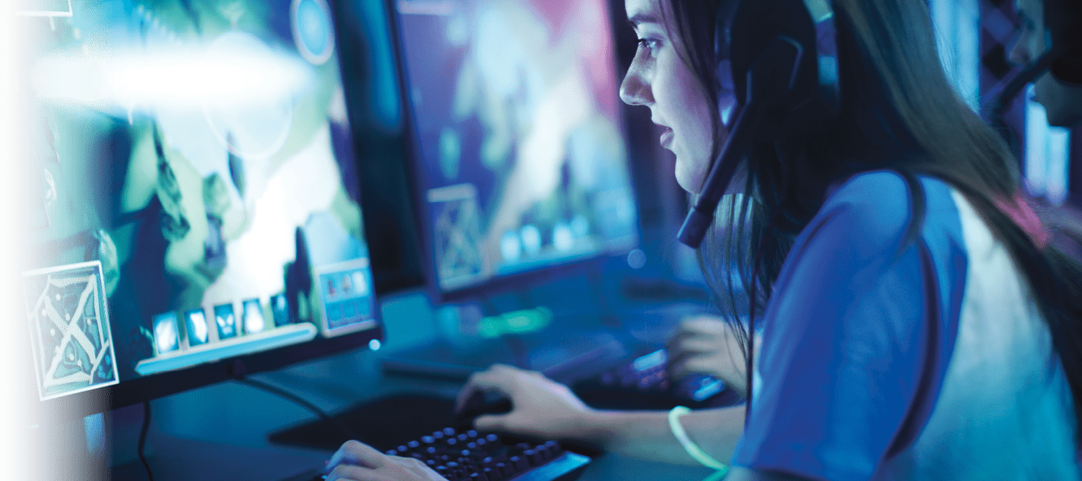 Professional Girl Gamer Plays in MMORPG  Strategy Video Game on Her Computer  She's Participating in Online Cyber Games Tournament, Plays at Home, or in Internet Cafe  She Wears Gaming Headset 