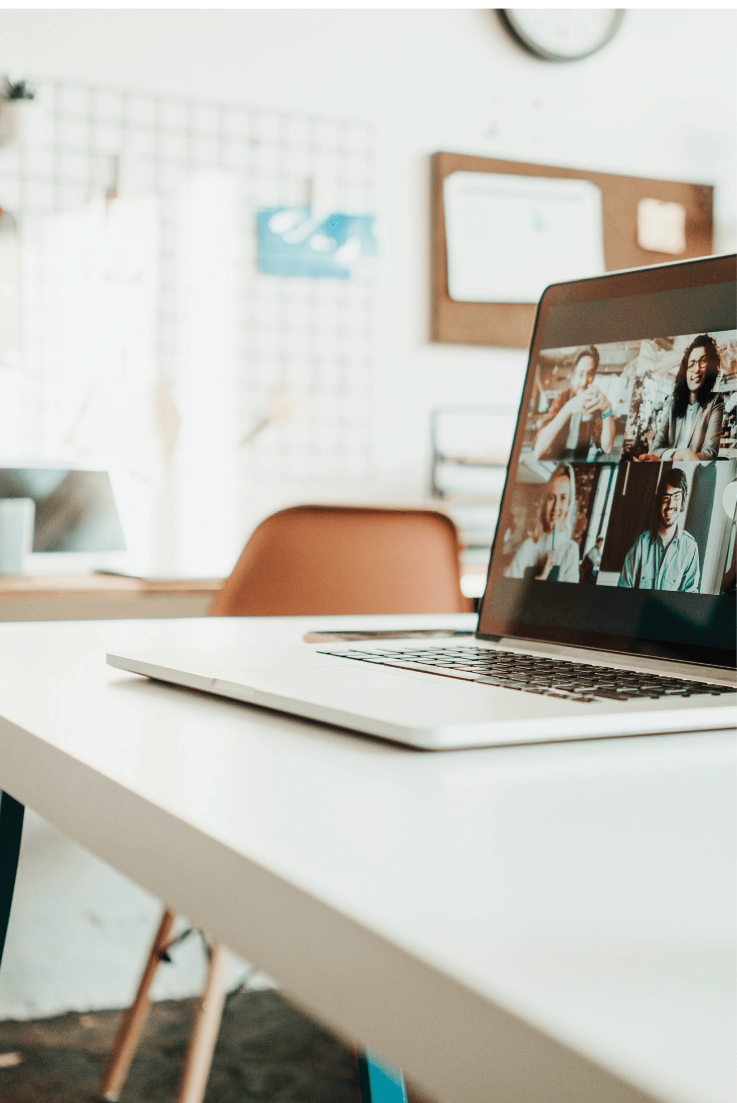 Laptop with video call conference standing on the desk in the middle of work space