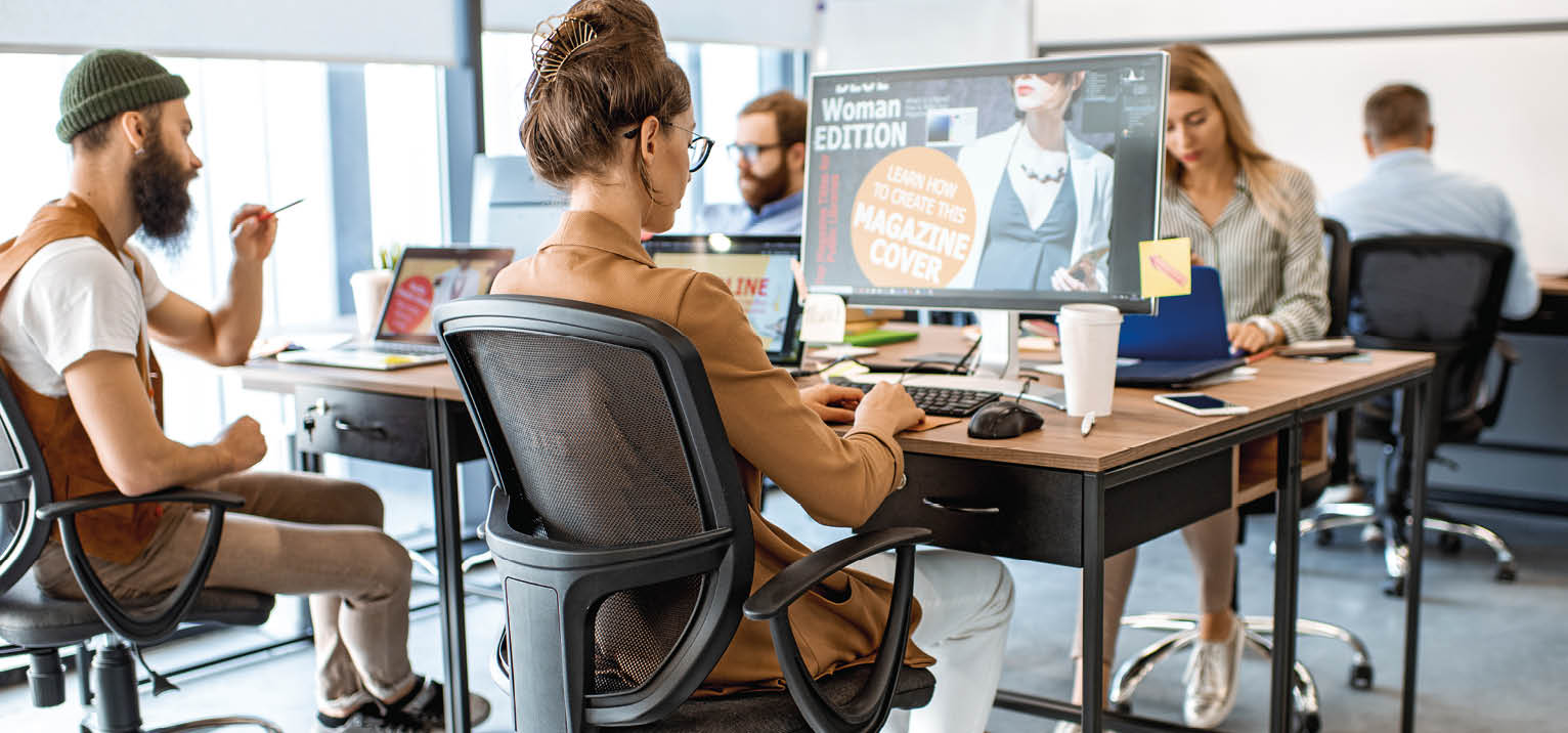 Group of diverse and creative colleagues working on computers in the modern office or coworking space, working on web design