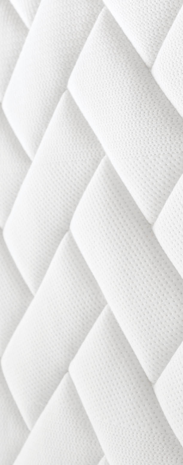 Close up shot of white orthopedic mattress top side surface pattern with a lot of copy space for text. Hypoallergenic foam matress for proper spinal alingment and pressure point relief. Background.