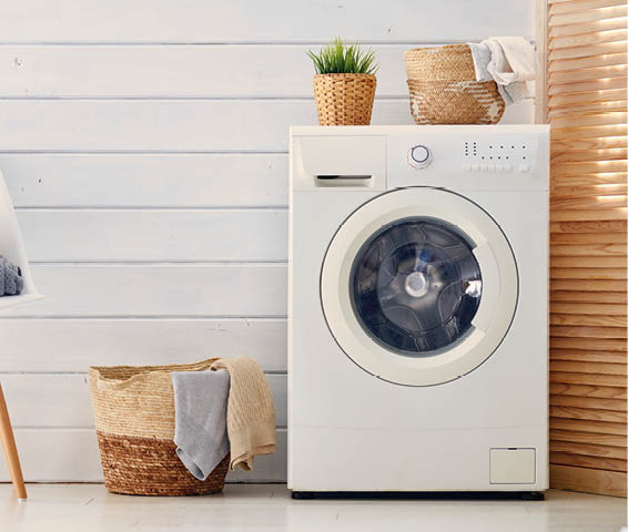 Interior of a real laundry room with a washing machine at home
