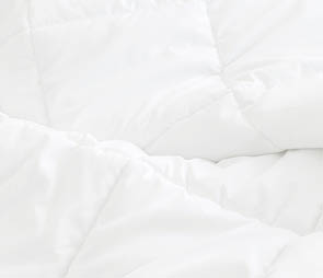 White bedding sheets background. Messy bed concept.