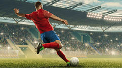 Professional soccer player with a ball in action. Soccer stadium with tribunes and fans cheering. Sports event
