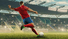 Professional soccer player with a ball in action. Soccer stadium with tribunes and fans cheering. Sports event