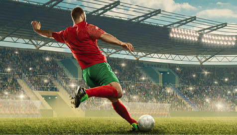 Professional soccer player with a ball in action. Soccer stadium with tribunes and fans cheering. Sports event