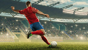 Professional soccer player with a ball in action. Soccer stadium with tribunes and fans cheering. Sports event