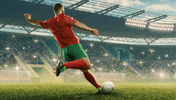 Professional soccer player with a ball in action. Soccer stadium with tribunes and fans cheering. Sports event