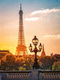Street lantern on the Alexandre III Bridge against the Eiffel Tower in Paris, France