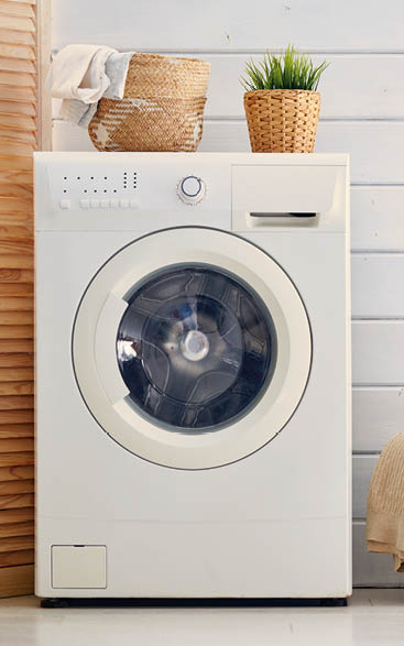 Interior of a real laundry room with a washing machine at home
