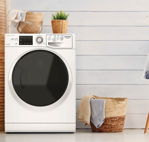 Interior of a real laundry room with a washing machine at home