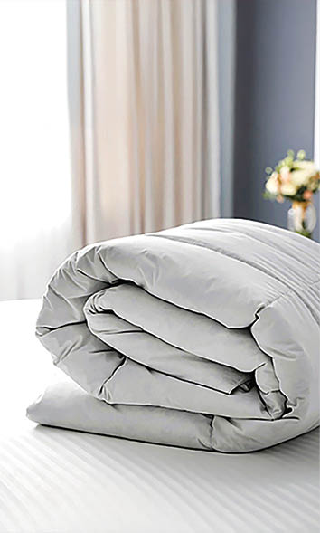 Soft folded blanket on bed at home