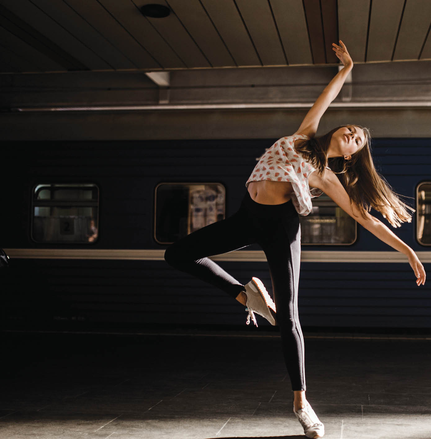 Caucasian woman dancing near train