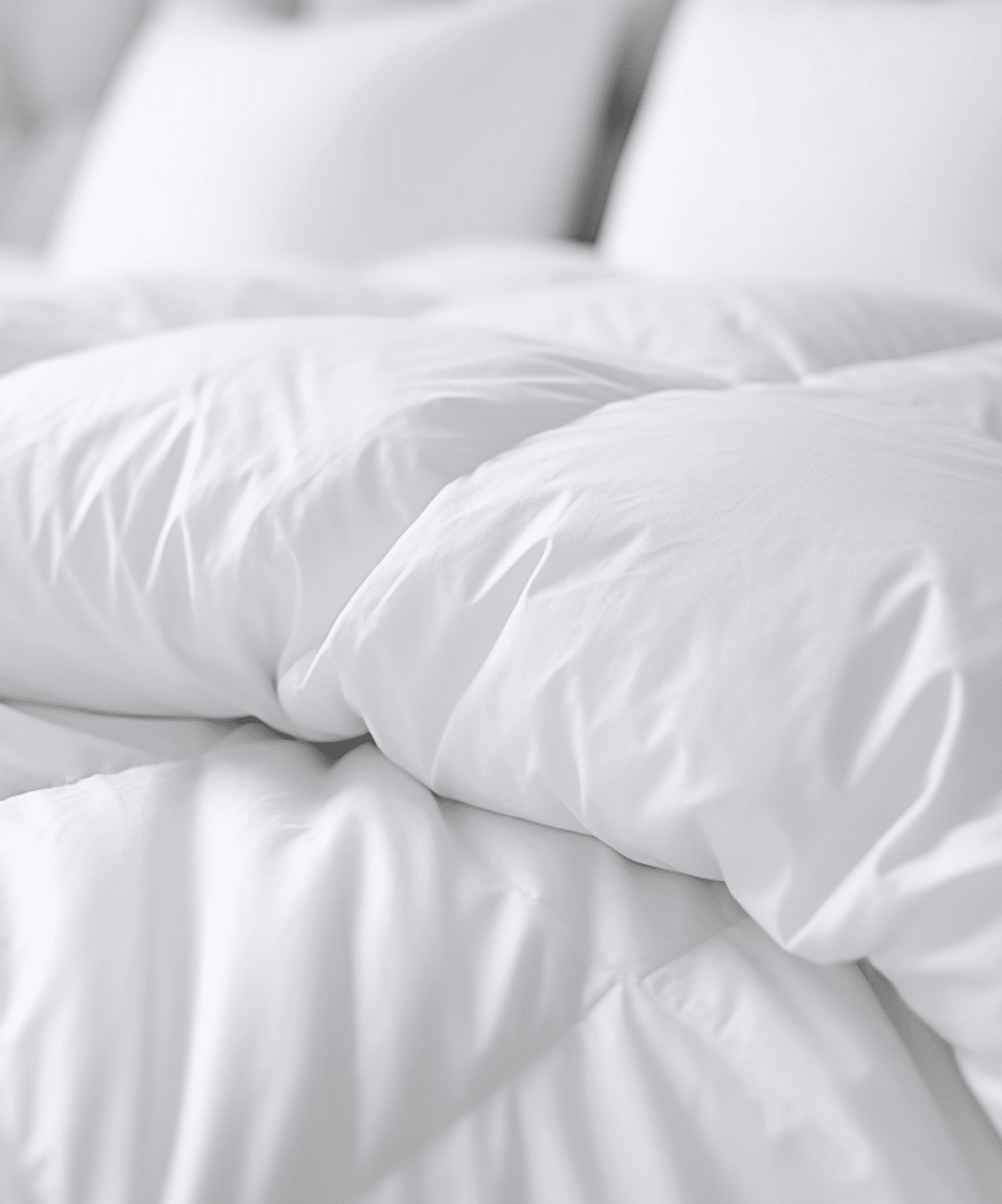 white duvet lying on the background of the headboard with pillows,close-up,the concept of preparing for the winter season,household chores,comfort in the house,hotel and home textiles