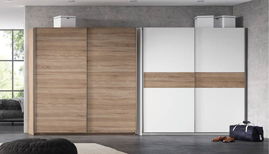 A large, open living room with a couch, a chair, and a bed. The room is decorated with wood and white walls, and has a large window. AI generated content