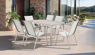 A patio set is arranged on a stone patio outside a house. AI generated content