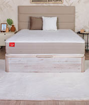 A bedroom with a bed, dresser, and mirror. The bed has a wooden headboard and a white comforter. AI generated content