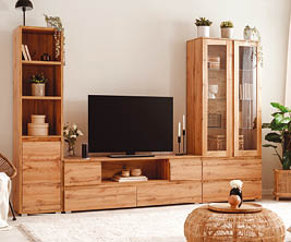 A living room with a flat screen TV, a couch, and a chair. The TV is on a stand and is placed on the left side of the room. A potted plant is on the right side of the room, and a vase is on the left side. AI generated content