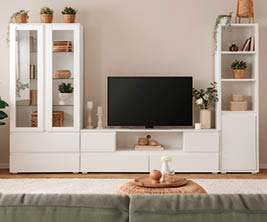 A living room with a flat screen TV, a couch, and a chair. The TV is on a stand and is placed on the left side of the room. A potted plant is on the right side of the room, and a vase is on the left side. AI generated content