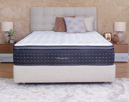 A bedroom with a bed, dresser, and mirror. The bed is a twin size and has a wooden headboard. A potted plant is on the dresser. AI generated content