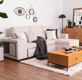 A living room with a blue couch, a coffee table, and a mirror. The room is decorated with a rug, a potted plant, and a bowl. AI generated content