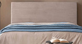 Minimalist bedroom decor with abstract artwork, a soft-toned bed, and sculptural bedside accessories in organic shapes.
