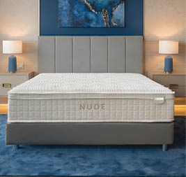 A bedroom with a bed, dresser, and mirror. The bed is a twin size and has a wooden headboard. A potted plant is on the dresser. AI generated content