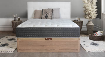 A bedroom with a bed, dresser, and mirror. The bed is a twin size and has a wooden headboard. A potted plant is on the dresser. AI generated content