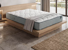 A bed with a white mattress and a red logo on the headboard. AI generated content