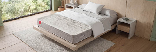 A bed with a white mattress and a red logo on the headboard. AI generated content
