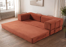 A large, orange couch is placed in a living room. AI generated content