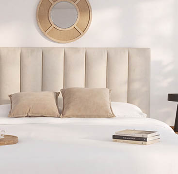 A bed with a white comforter and pillows. AI generated content