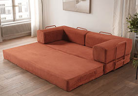 A large, orange couch is placed in a living room. AI generated content