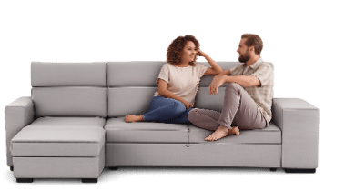 A man and woman are sitting on a couch, facing each other. AI generated content