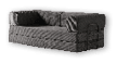 A black leather couch with a nude figure on it. AI generated content