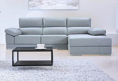 A large couch is placed in a living room with a coffee table in front of it. The room is clean and well-lit. AI generated content