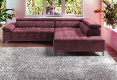 A large couch with a purple cushion is placed in front of a window. AI generated content