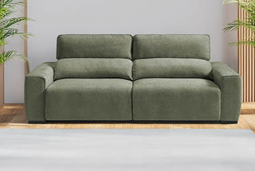 A green couch is placed in a living room with a white wall behind it. AI generated content