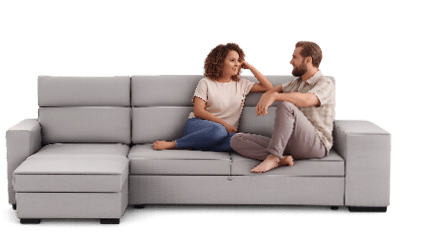 A man and woman are sitting on a couch, facing each other. AI generated content