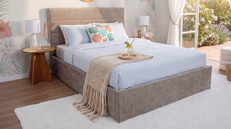 A bed with a white headboard and a blue pillow. AI generated content
