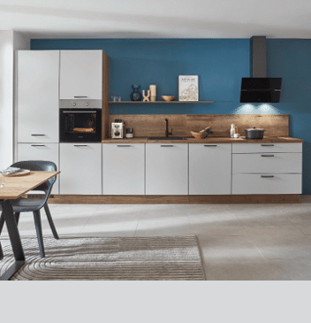 A large, clean kitchen with white cabinets and blue walls. A stove top oven is visible, along with a microwave. A dining table is surrounded by chairs, and a potted plant is placed nearby. A vase is also present in the room. AI generated content