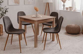 A wooden dining table with four chairs around it. AI generated content