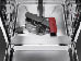 A red and black pair of scissors sits on a stainless steel counter. AI generated content