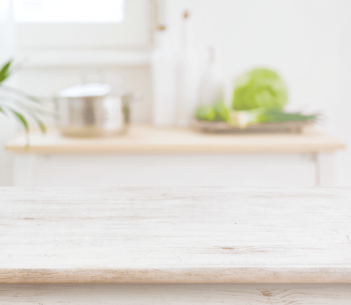A kitchen counter with a bowl of lettuce and a pot on it. AI generated content