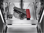 A red and black pair of scissors sits on a stainless steel counter. AI generated content