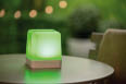 A green lighted object is sitting on a table. AI generated content