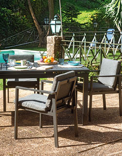 A patio table with chairs and a lamp. AI generated content