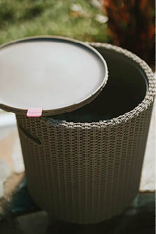 A wicker basket with a lid is sitting on a table. AI generated content
