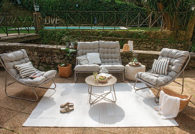 A patio set with two chairs and a table is arranged on a white rug. AI generated content