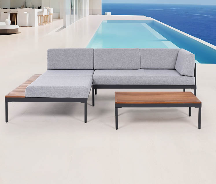 A large couch is placed on a patio near a pool. AI generated content